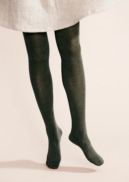 A person wearing knit tights in green.