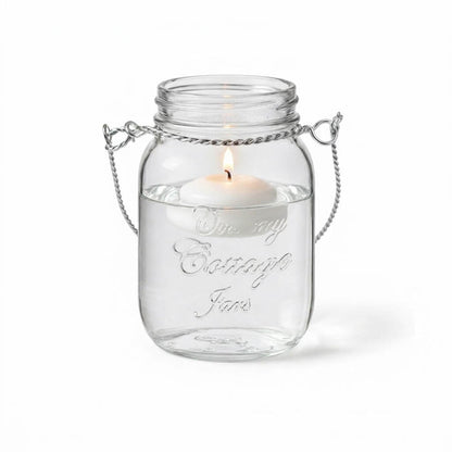 Uncluttered Small Mason Jar with Handle and lit floating candle