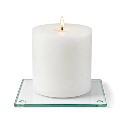 A clean product studio shot of a lit white candle on a clear glass Square Coaster 4"