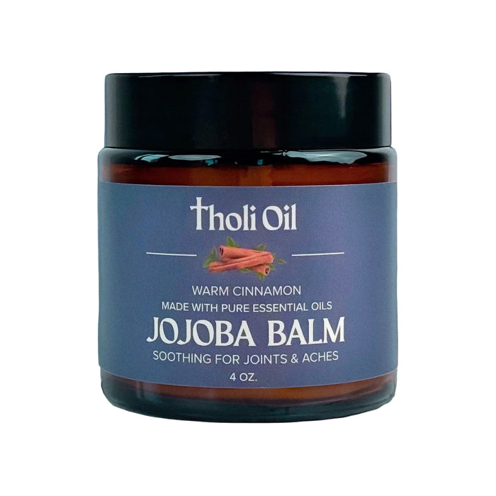 Jojoba balm jar with 'tholi Oil' branding on a white background