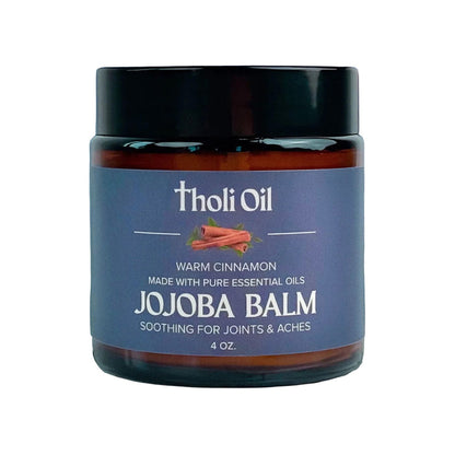 Jojoba balm jar with 'tholi Oil' branding on a white background