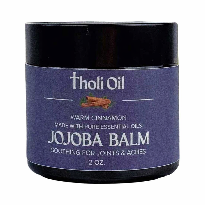 Jojoba balm jar with purple label and black lid on a white background