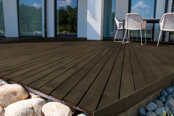 Retique It Multi-purpose Smooth Finish Kit in Charcoal for exterior wood surfaces, featuring a matte top coat on decking.