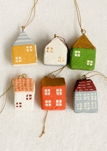 Set of colorful house-shaped ornaments on a textured white background