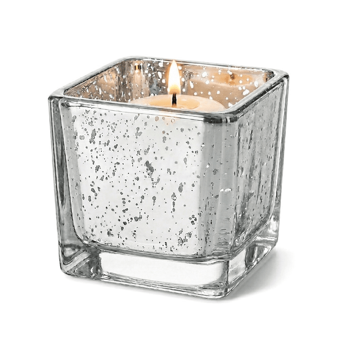 Silver mercury square votive holder with lit candle on white background