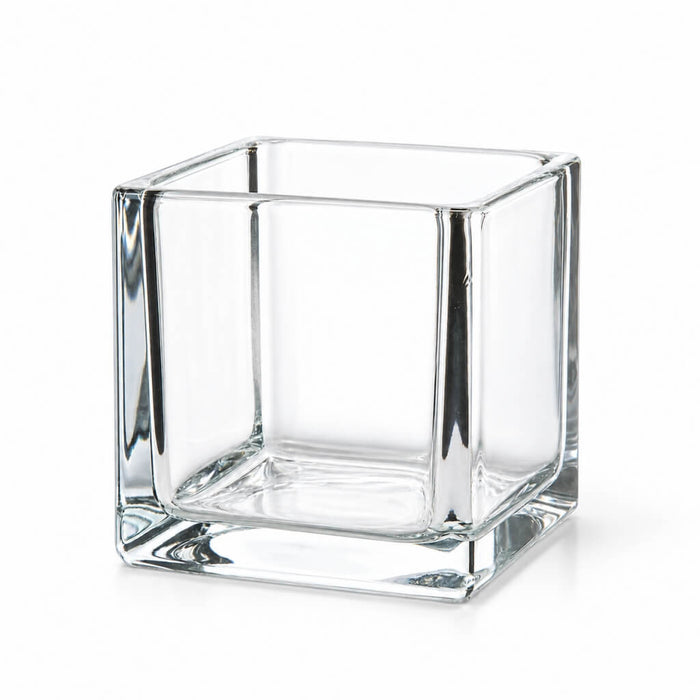 Empty 4" square glass cube vase on a white background