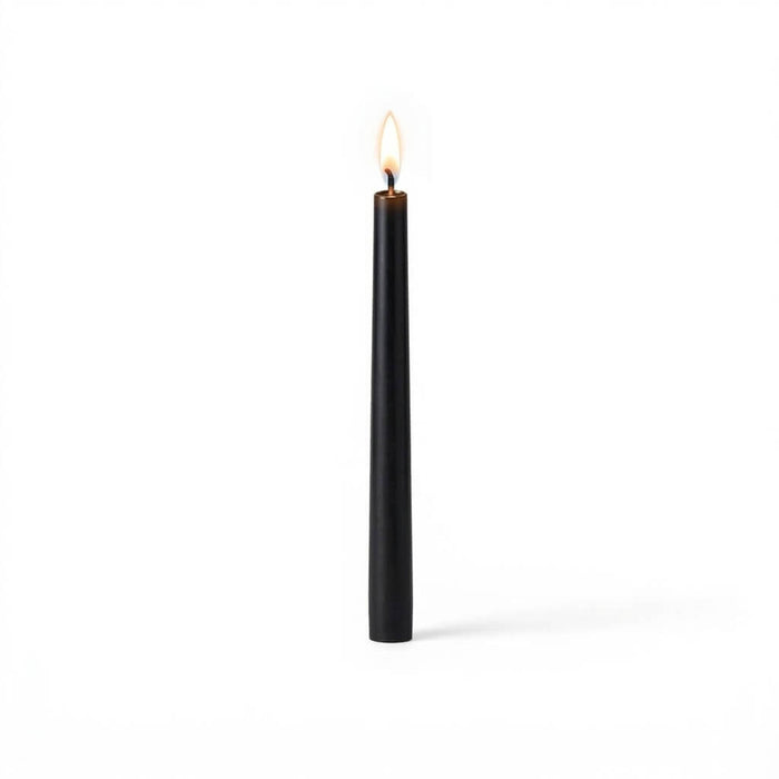 Black taper candle burning on white background