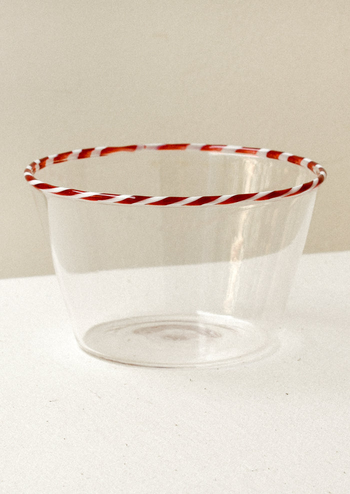 Clear glass blow with a red striped rim