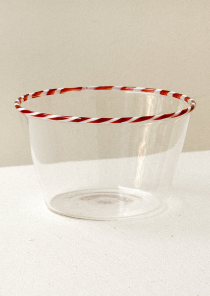 Clear glass blow with a red striped rim